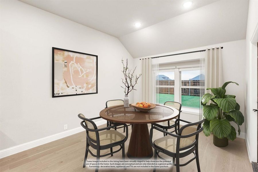 Dining area with round wood table, four chairs, vaulted ceiling, and sliding glass door to backyard