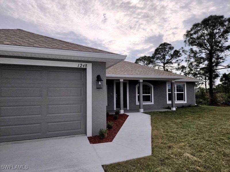 Front exterior of a new home in Lehigh Acres, Lehigh Acres, FL, highlighting curb appeal (Image 2).