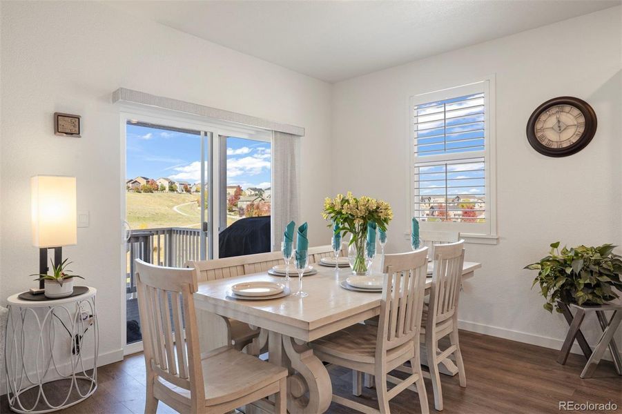Sun-filled dining area with space for 4-6 and sliding doors to the upper deck and scenic views of the open space.