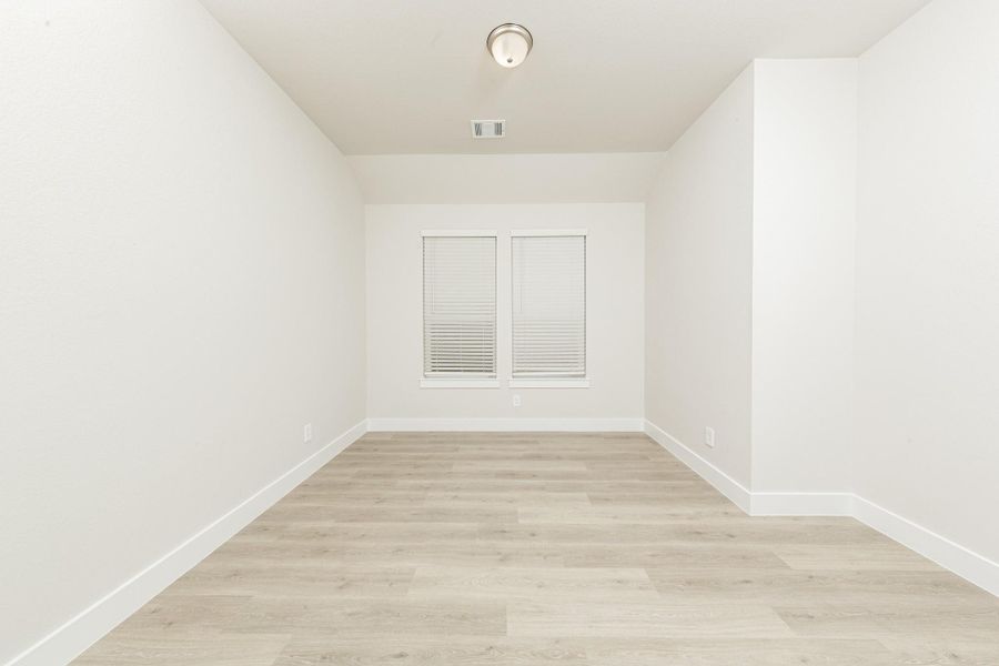 This dedicated home office offers a flexible layout, centered around a thoughtfully designed, integrated wall niche perfect for a desk setup or built-in shelving, providing a seamless and uncluttered work environment.