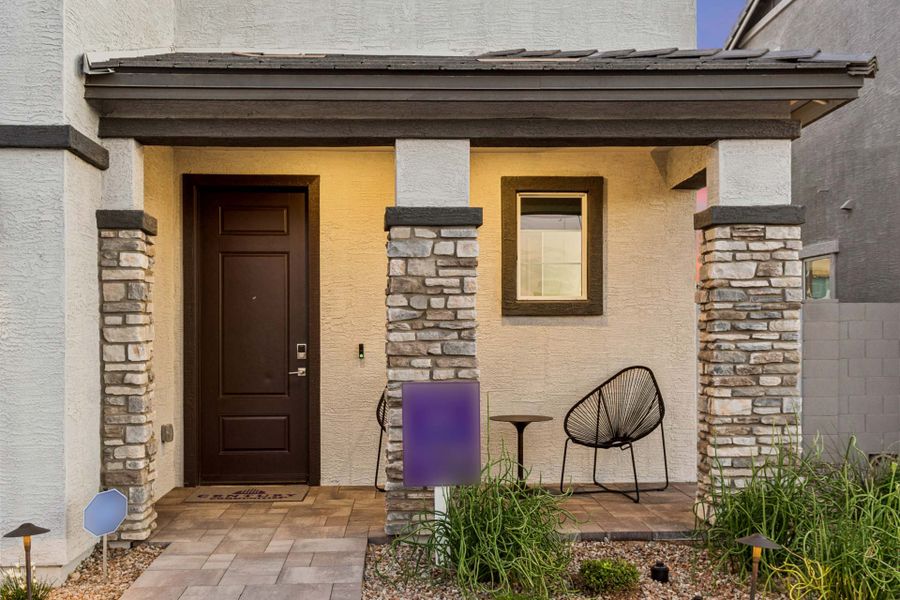 A house with a patio and chairs.