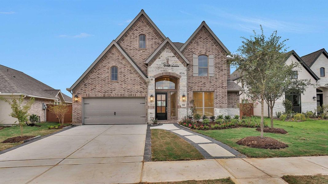 Front exterior of a new home in Elyson 55', Katy, TX, highlighting curb appeal (Image 2). Front exterior of a new home in Elyson 55', Katy, TX, highlighting curb appeal (Image 2).