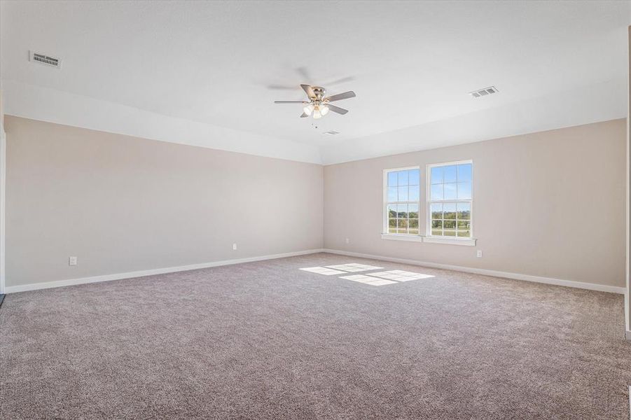 Bonus room featuring carpet flooring and ceiling fan Bonus room featuring carpet flooring and ceiling fan