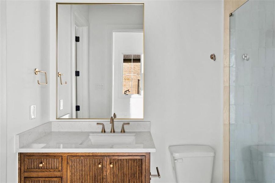 Full bathroom featuring vanity and tiled shower Full bathroom featuring vanity and tiled shower