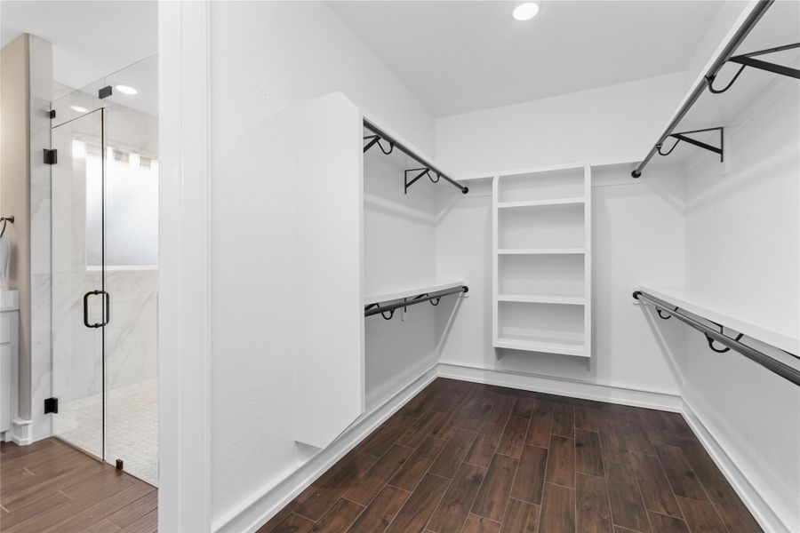Walk in closet with dark wood-type flooring Walk in closet with dark wood-type flooring