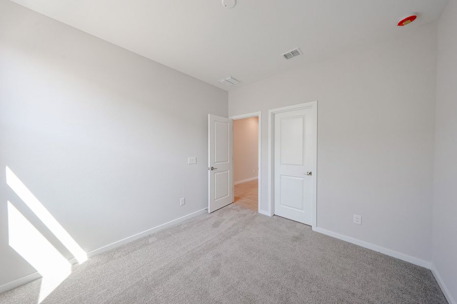A hallway with white doors.