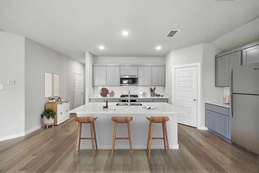Kitchen in the Emmy II home plan by Trophy Signature Homes - REPRESENTATIVE PHOTO