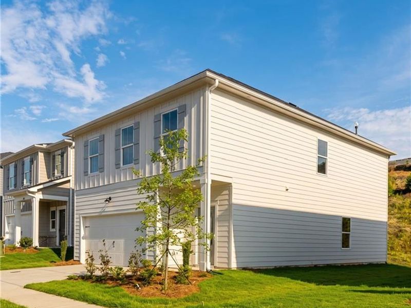 Front exterior of a new home in The Bluffs, Canton, GA, highlighting curb appeal (Image 2). Front exterior of a new home in The Bluffs, Canton, GA, highlighting curb appeal (Image 2).