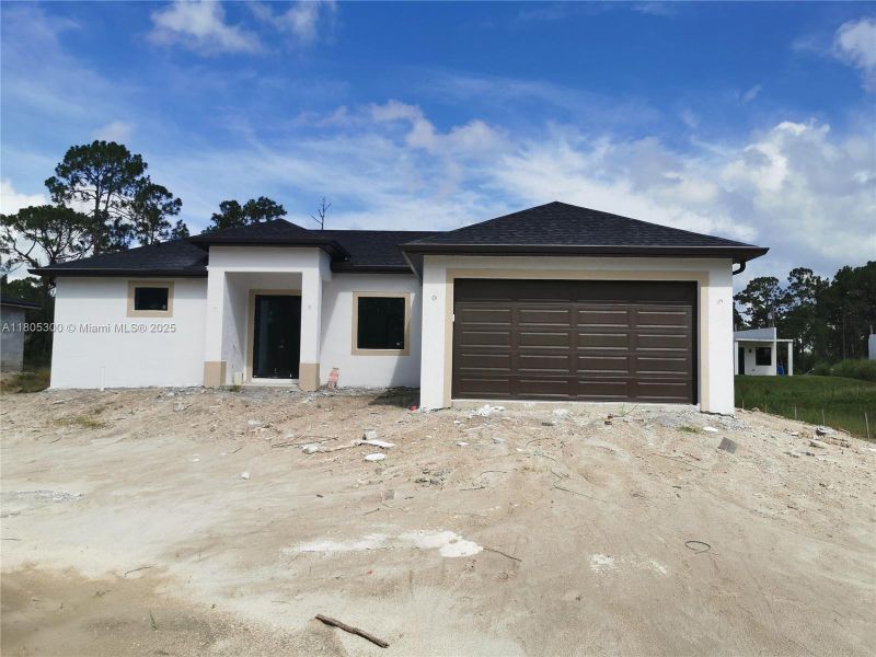 Front exterior of a new home in , Lehigh Acres, FL, highlighting curb appeal (Image 2).