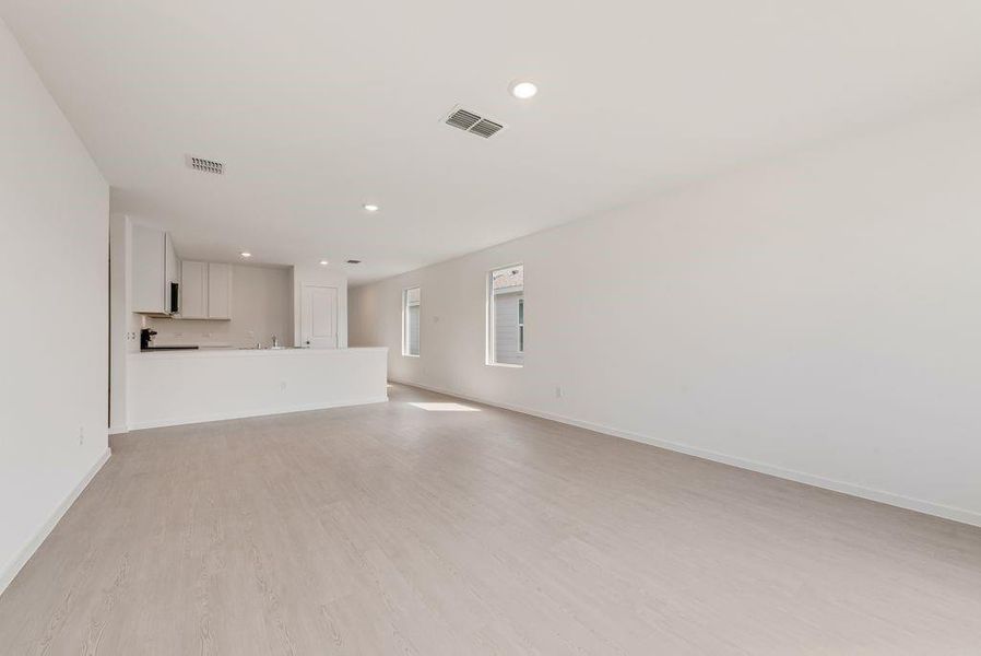 Unfurnished living room with light wood-type flooring and recessed lighting