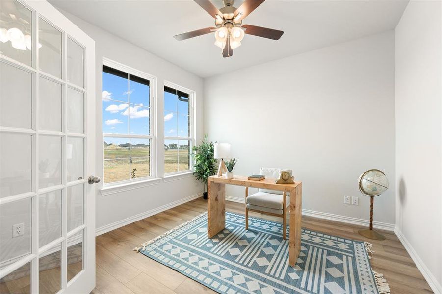 Office area featuring light wood-type flooring and ceiling fan
