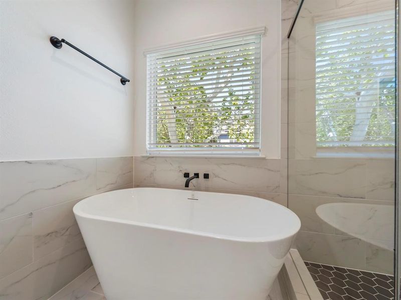 The Primary Bathroom is stunning with the stand-alone soaking tub! (Sample photos of a completed Warwick floor plan. The image may feature alternative selections and/or upgrades.)