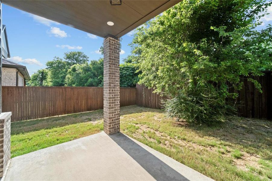 Fenced backyard with a patio