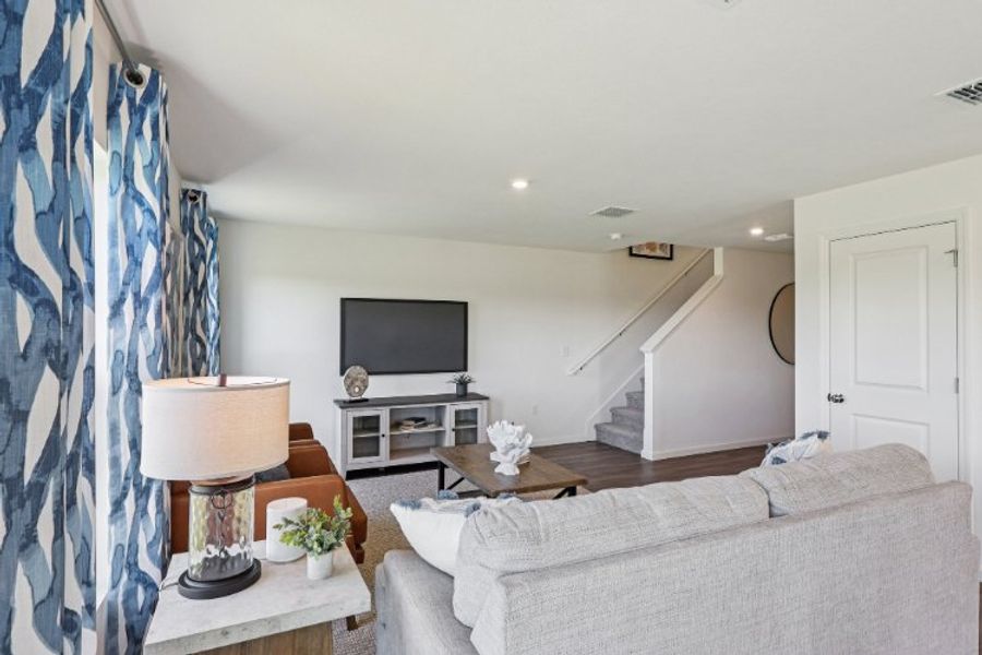 A living room with a couch and a tv.