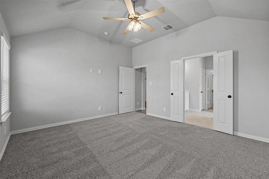 carpet, a ceiling fan, and high vaulted ceiling carpet, a ceiling fan, and high vaulted ceiling
