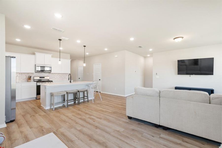 Living area featuring light wood-type flooring and recessed lighting Living area featuring light wood-type flooring and recessed lighting