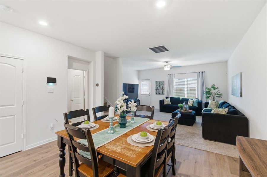 The main living area features light-colored walls, recessed lighting, and a ceiling fan