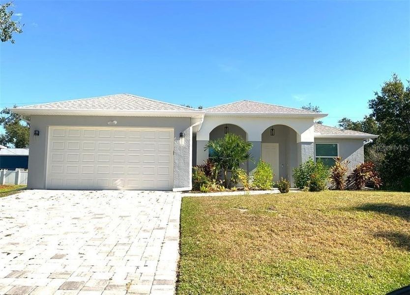 Front exterior of a new home in , Port Charlotte, FL, highlighting curb appeal (Image 18).