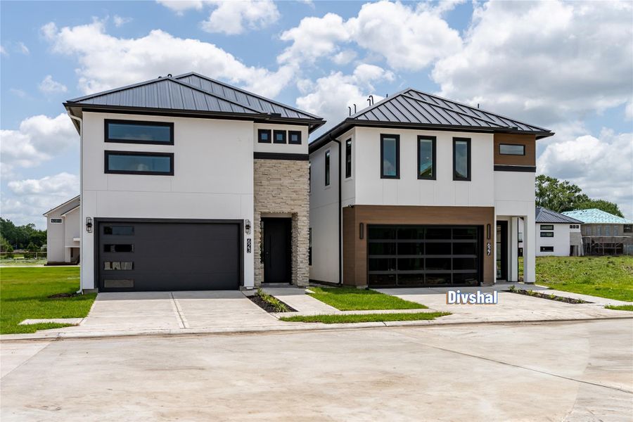 Grand curb appeal sets the tone for this architectural masterpiece by Shree Homes, featuring a stunning modern stucco façade complemented by premium composite decking accents Grand curb appeal sets the tone for this architectural masterpiece by Shree Homes, featuring a stunning modern stucco façade complemented by premium composite decking accents