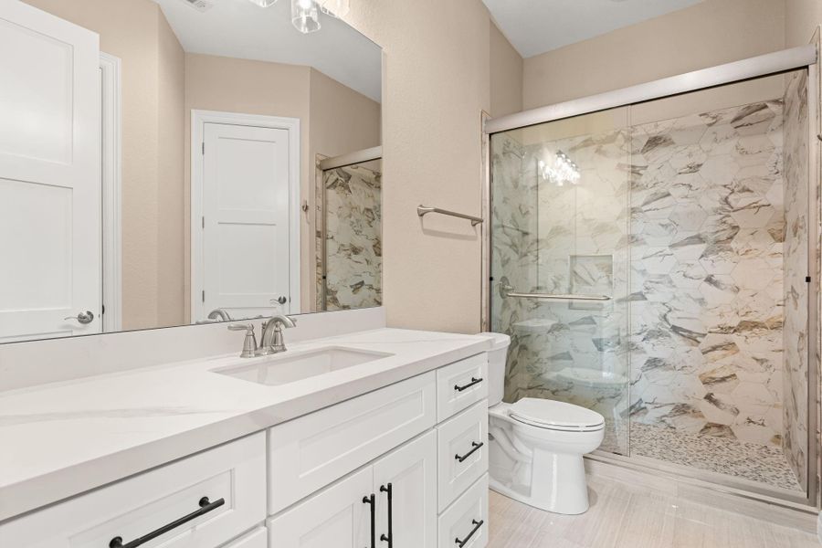 Spacious bath with walk-in shower, linen closet and walk-in closet.