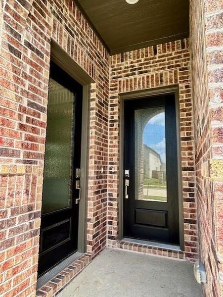 Brick exterior showcasing the primary entrance and the in-law suite entrance