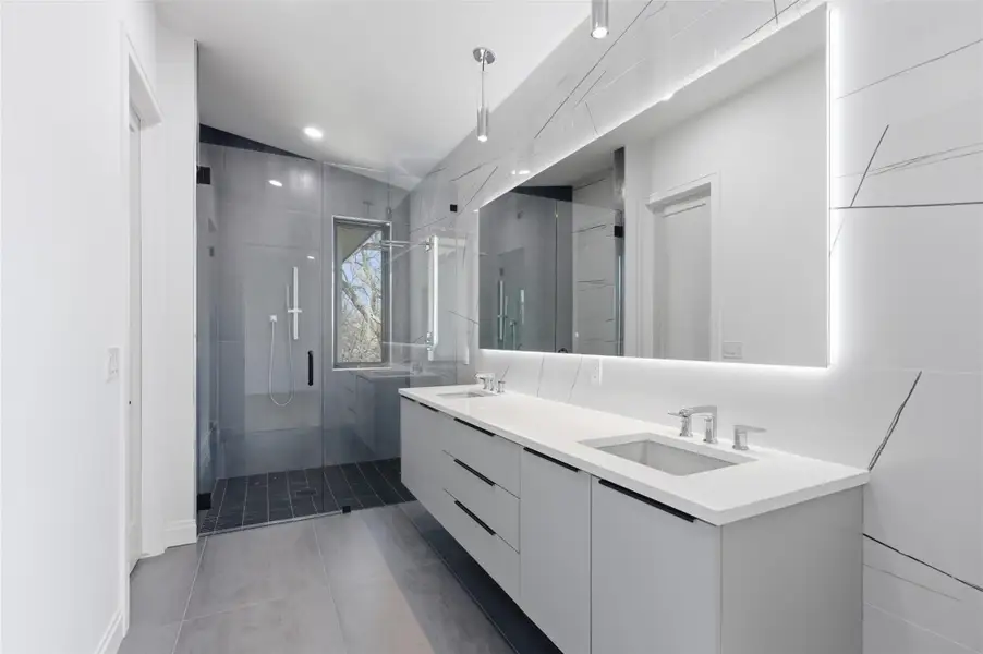 Primary Bathroom with a floating vanity and LED mirror.