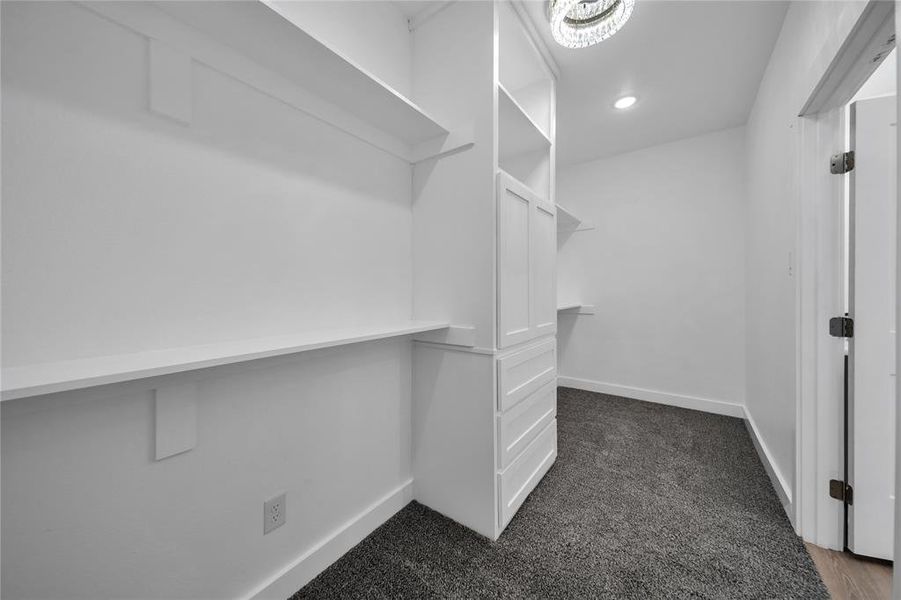 Walk in closet with dark carpet