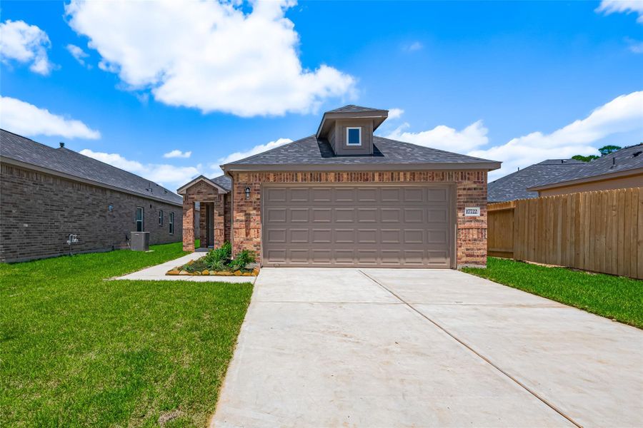 Front exterior of a new home in Sunterra, Katy, TX, highlighting curb appeal (Image 24).