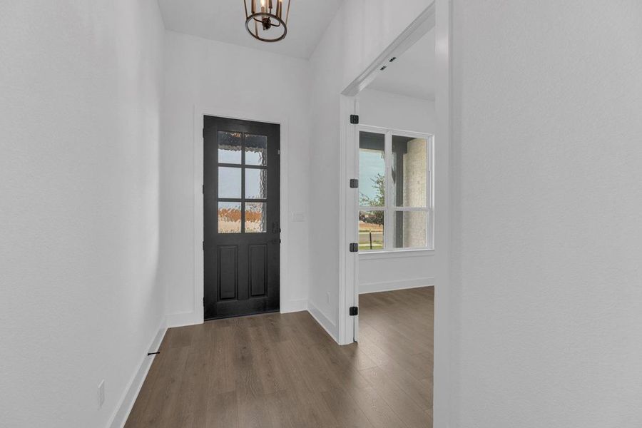 Entrance foyer with dark wood finished floors and a chandelier Entrance foyer with dark wood finished floors and a chandelier