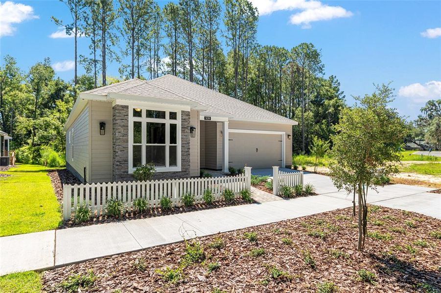 Front exterior of a new home in Fairway Pointe at West End, Newberry, FL, highlighting curb appeal (Image 25). Front exterior of a new home in Fairway Pointe at West End, Newberry, FL, highlighting curb appeal (Image 25).