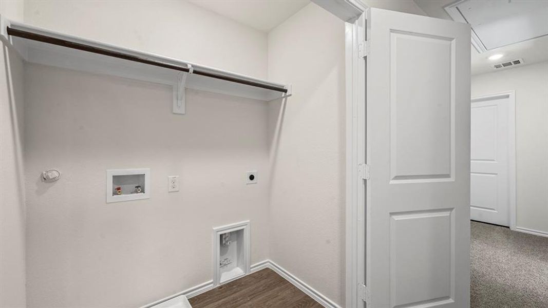 Laundry room featuring hookup for a washing machine, hookup for an electric dryer, dark wood-style floors, hookup for a gas dryer, and attic access