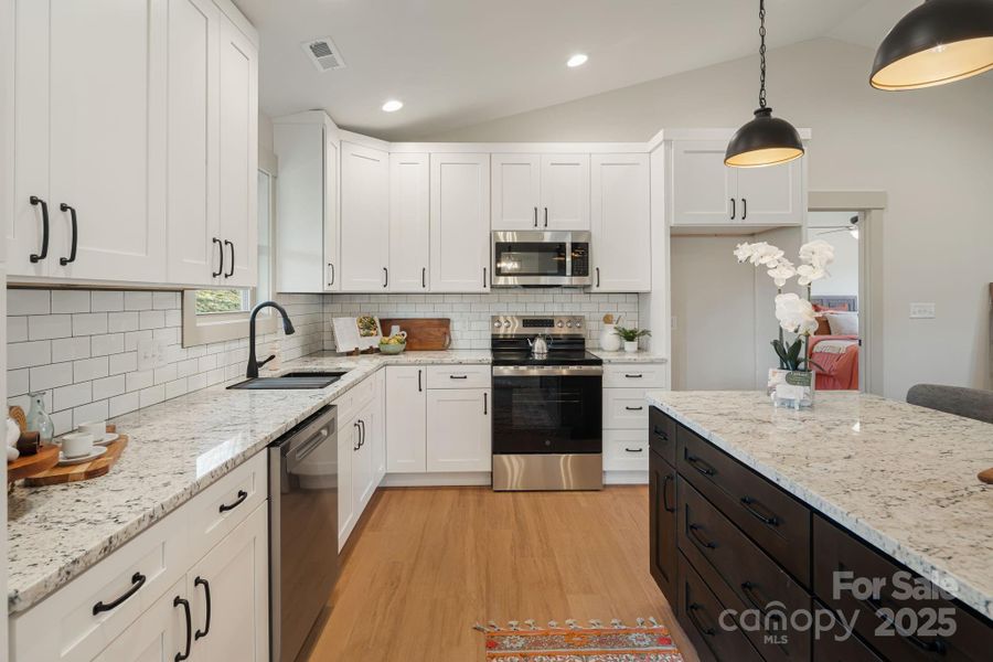 Spacious kitchen with counter space and backsplash Spacious kitchen with counter space and backsplash