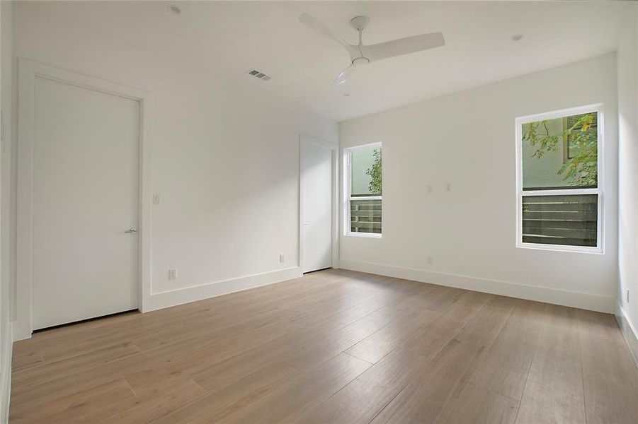 Unfurnished room featuring ceiling fan and light hardwood / wood-style flooring