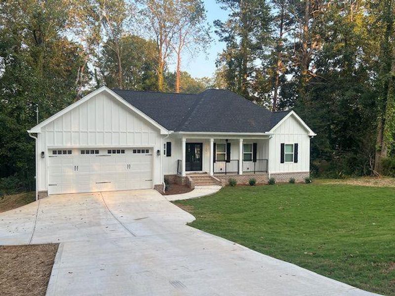 Front exterior of a new home in , Griffin, GA, highlighting curb appeal (Image 1).