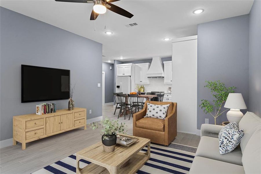 Living area featuring wood tiled floors, recessed lighting, and ceiling fan Living area featuring wood tiled floors, recessed lighting, and ceiling fan