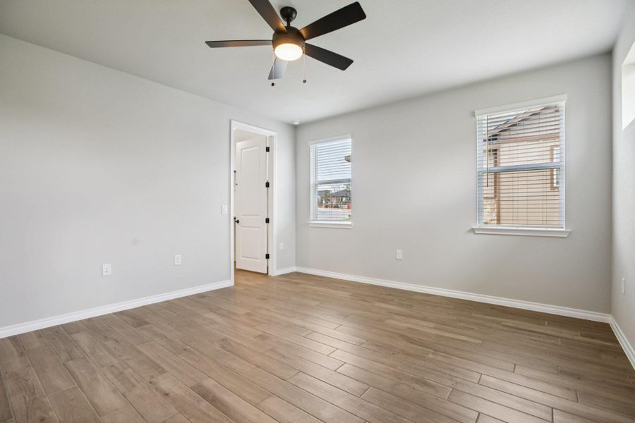 Empty room featuring light wood-type flooring and ceiling fan Empty room featuring light wood-type flooring and ceiling fan