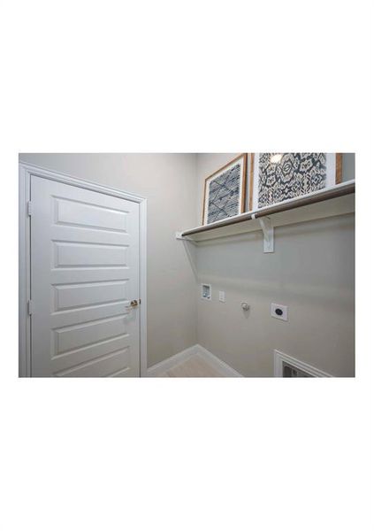 Washroom with hookup for an electric dryer and gas dryer hookup