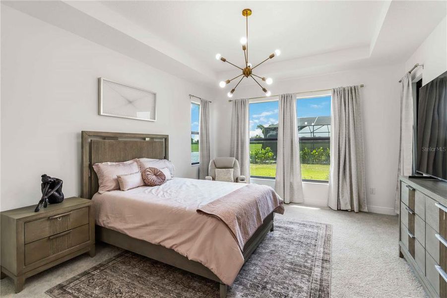 Owners Suite with custom drapes, lighting, and tray ceiling.