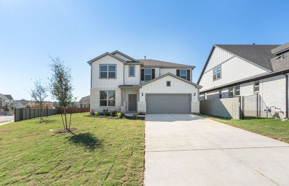Front exterior of a new home in Saddleback at Santa Rita Ranch, Liberty Hill, TX, highlighting curb appeal (Image 2). Front exterior of a new home in Saddleback at Santa Rita Ranch, Liberty Hill, TX, highlighting curb appeal (Image 2).