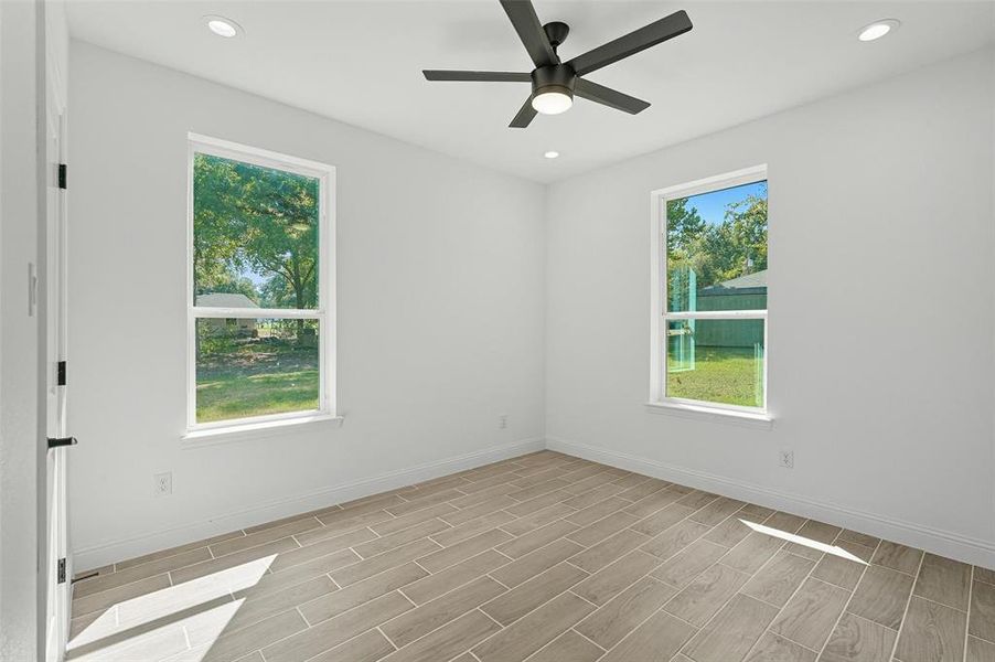Spare room featuring wood finish floors, recessed lighting, and a ceiling fan Spare room featuring wood finish floors, recessed lighting, and a ceiling fan