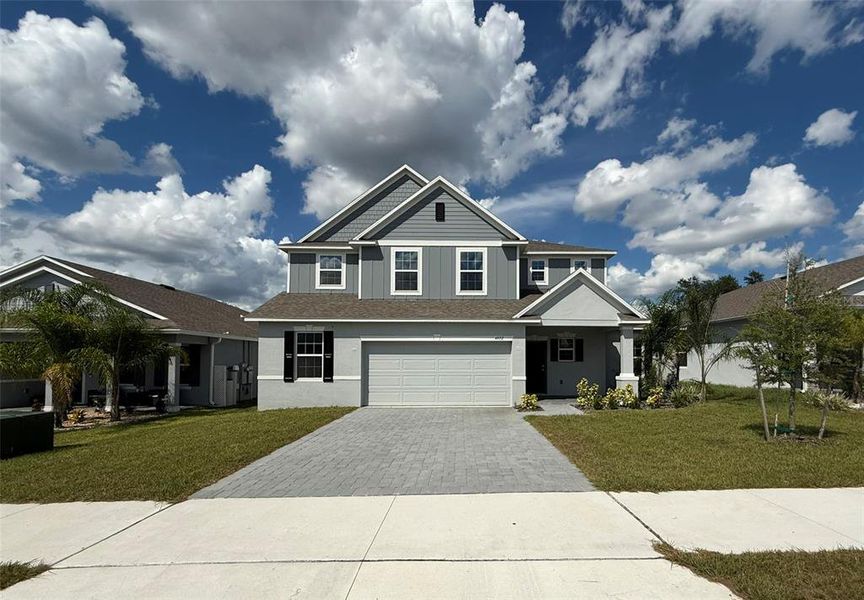 Front exterior of a new home in , Mascotte, FL, highlighting curb appeal (Image 1).