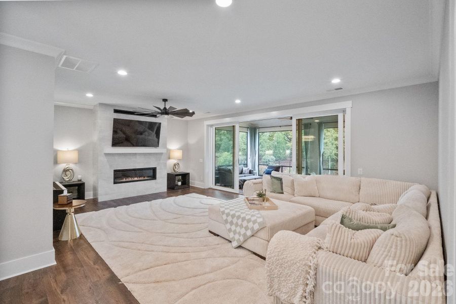 Large living space with modern fireplace and sliding doors to outdoor screen patio