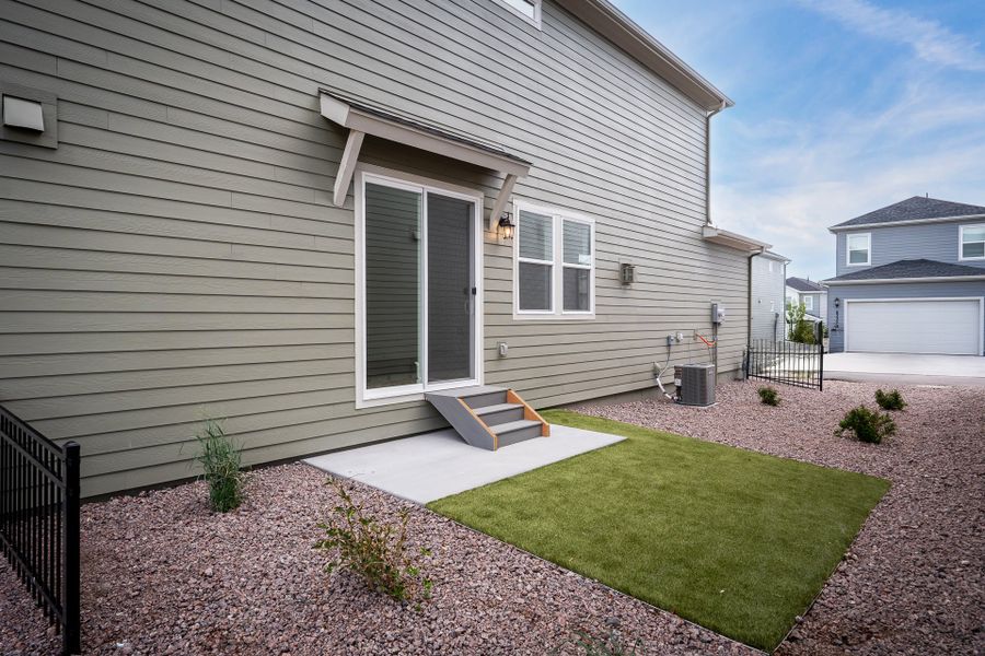 Exterior details and patio area of a home in Revel Crossing at Wolf Ranch – The Ascent Collection, Colorado Springs (Image 3).