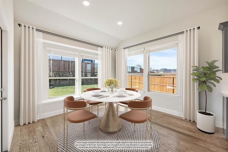 Dining area with round white table, four chairs, hardwood floors, and large windows with backyard view Dining area with round white table, four chairs, hardwood floors, and large windows with backyard view