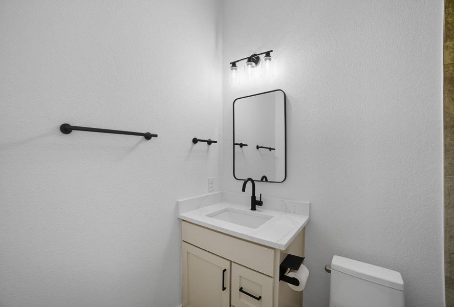 Half bathroom with vanity and toilet Half bathroom with vanity and toilet