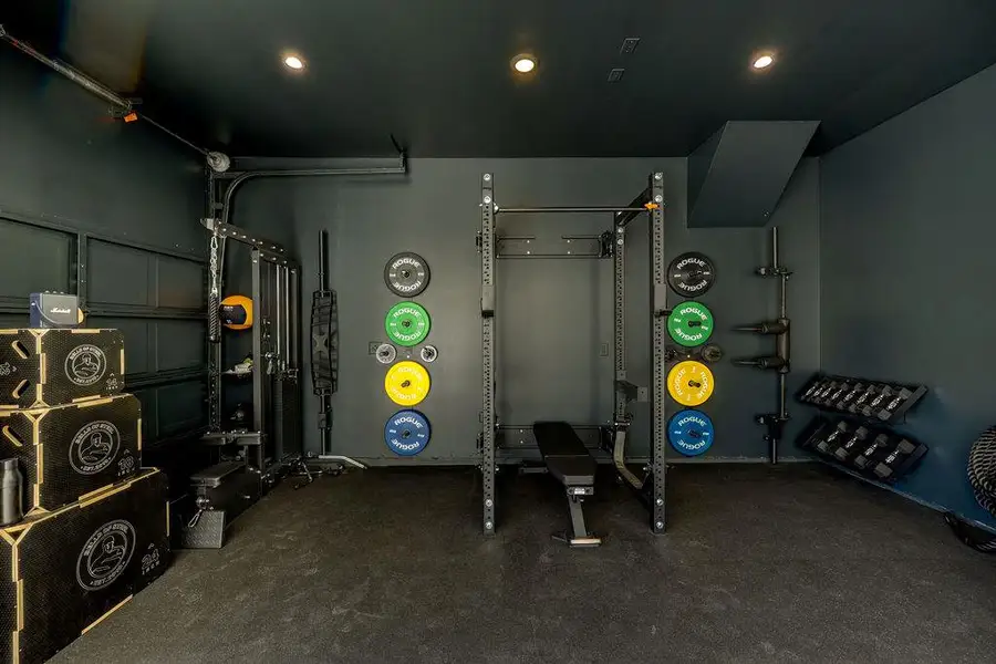 Exercise area with a garage and recessed lighting
