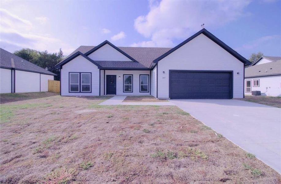 View of front of home with driveway, an attached garage, and a shingled roof View of front of home with driveway, an attached garage, and a shingled roof