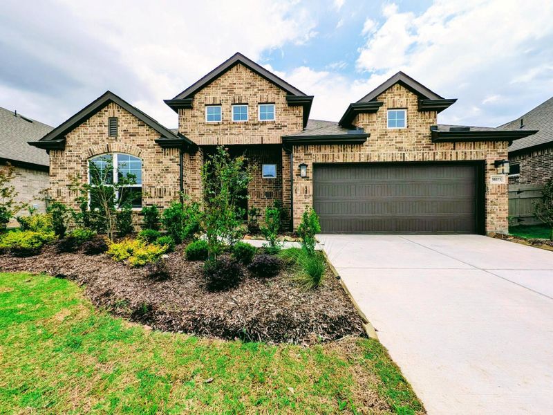 Front exterior of a new home in Artavia, Conroe, TX, highlighting curb appeal (Image 1). Front exterior of a new home in Artavia, Conroe, TX, highlighting curb appeal (Image 1).