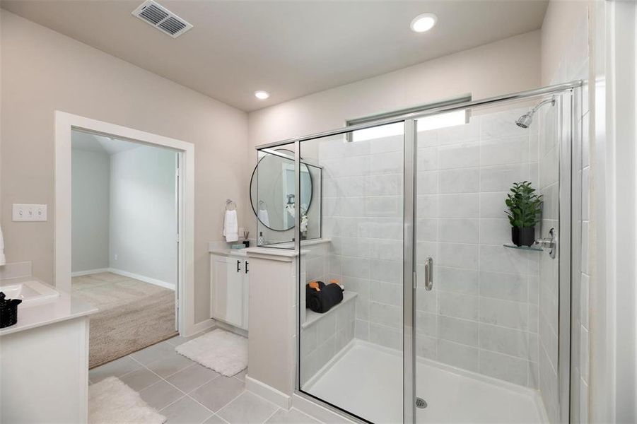 Full bath with vanity, a shower stall, light colored carpet, and light tile patterned flooring Full bath with vanity, a shower stall, light colored carpet, and light tile patterned flooring