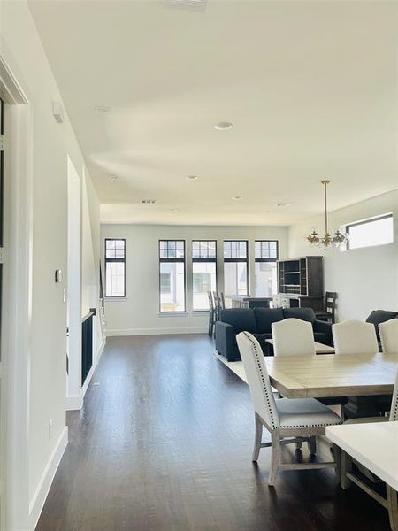 Dining area featuring plenty of natural light, dark wood-style floors, a chandelier, and recessed lighting Dining area featuring plenty of natural light, dark wood-style floors, a chandelier, and recessed lighting
